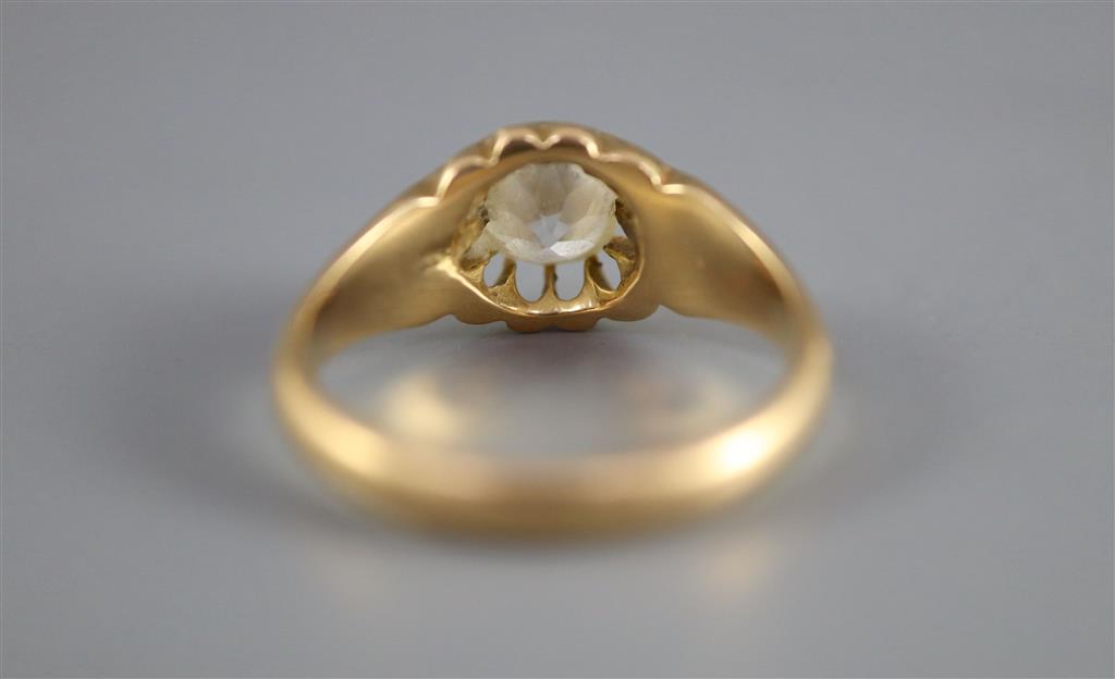 An early 20th century gold and old cushion cut claw set solitaire diamond ring, with fluted shoulders,